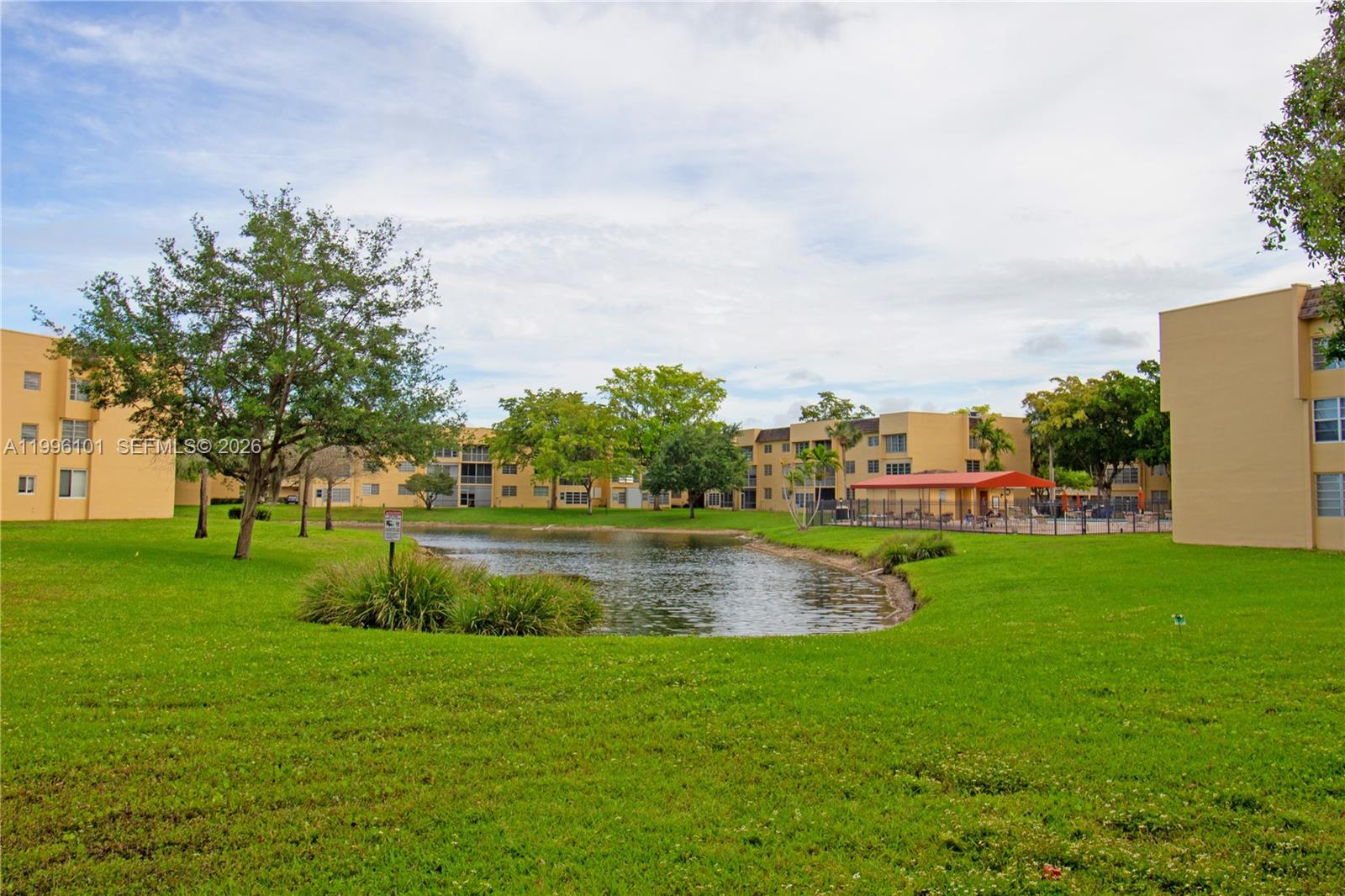 6020 Northwest 64th Avenue, Unit 108 Tamarac, FL 33319 - Photo 15 of 19 a view of outdoor space lake and green space