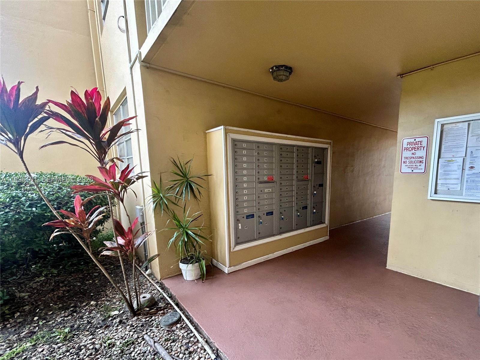 6020 Northwest 64th Avenue, Unit 108 Tamarac, FL 33319 - Photo 19 of 19 a view of an entryway with a flower pot