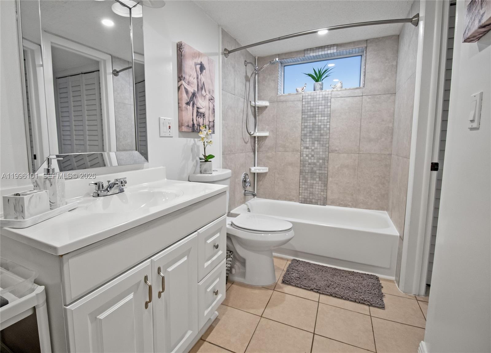 6020 Northwest 64th Avenue, Unit 108 Tamarac, FL 33319 - Photo 3 of 19 a bathroom with a sink toilet and shower