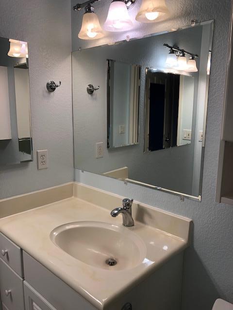 1410 Bel Air Drive, Unit 304 Concord, CA 94521 - Photo 10 of 23 a bathroom with a sink and a mirror