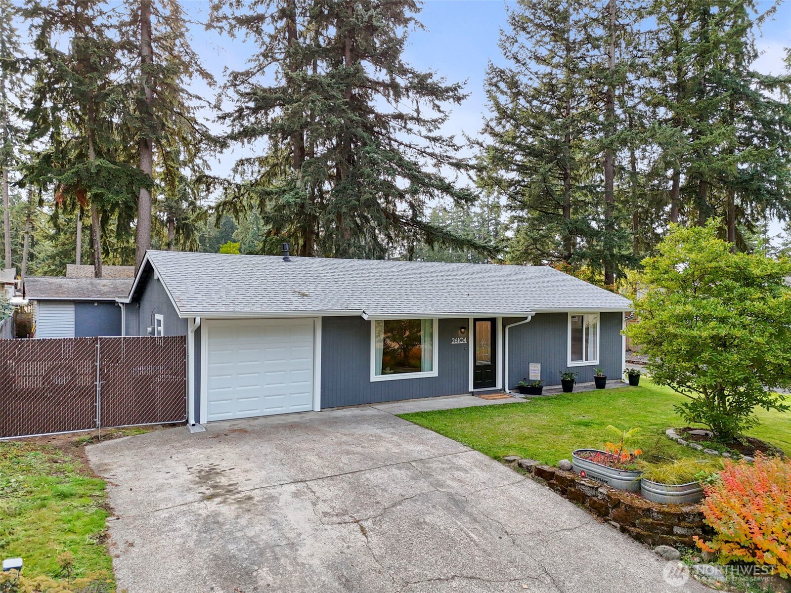 a front view of a house with a garden