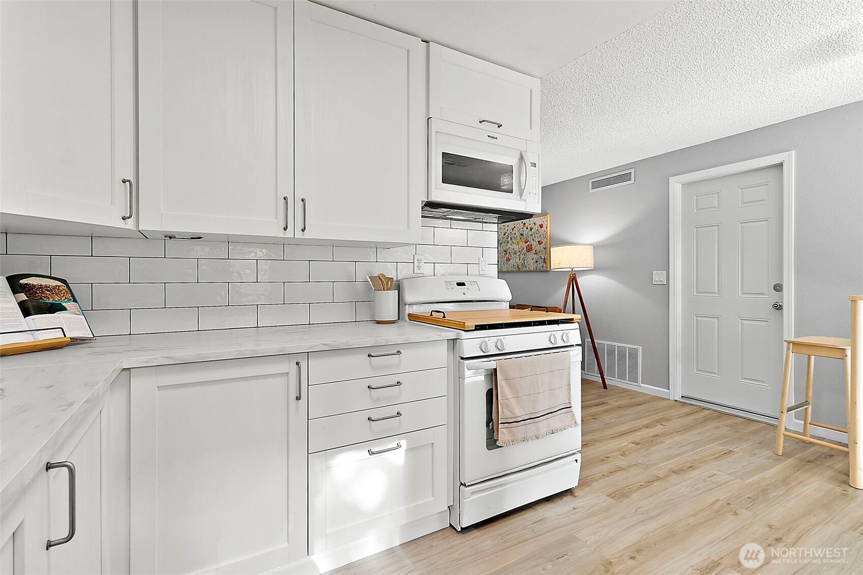 26104 195th Place Southeast Covington, WA 98042 - Photo 11 of 29 a kitchen with granite countertop white cabinets and white appliances