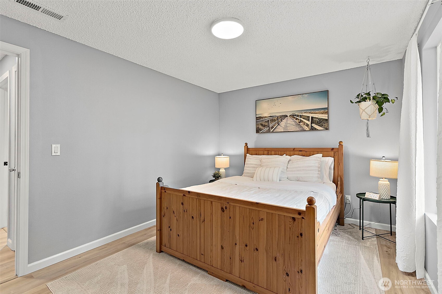 26104 195th Place Southeast Covington, WA 98042 - Photo 19 of 29 a bedroom with a bed and a painting on the wall