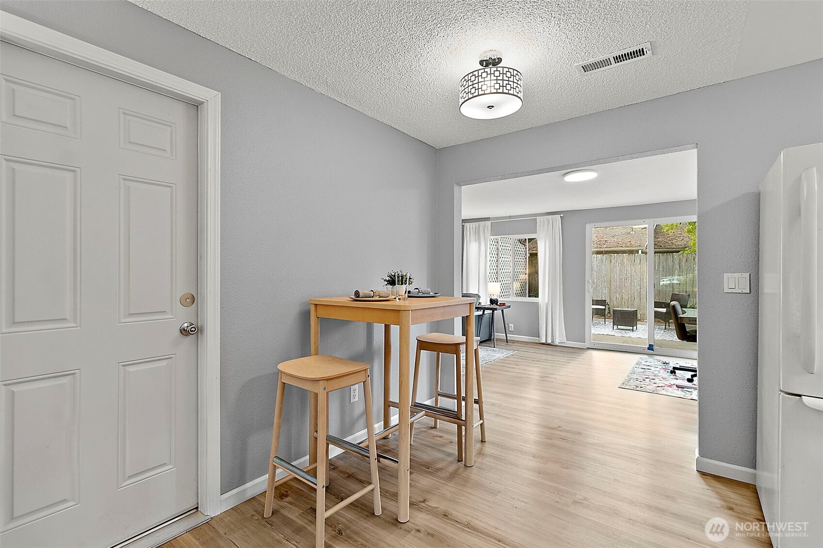 26104 195th Place Southeast Covington, WA 98042 - Photo 7 of 29 a view of a dining room with furniture and wooden floor