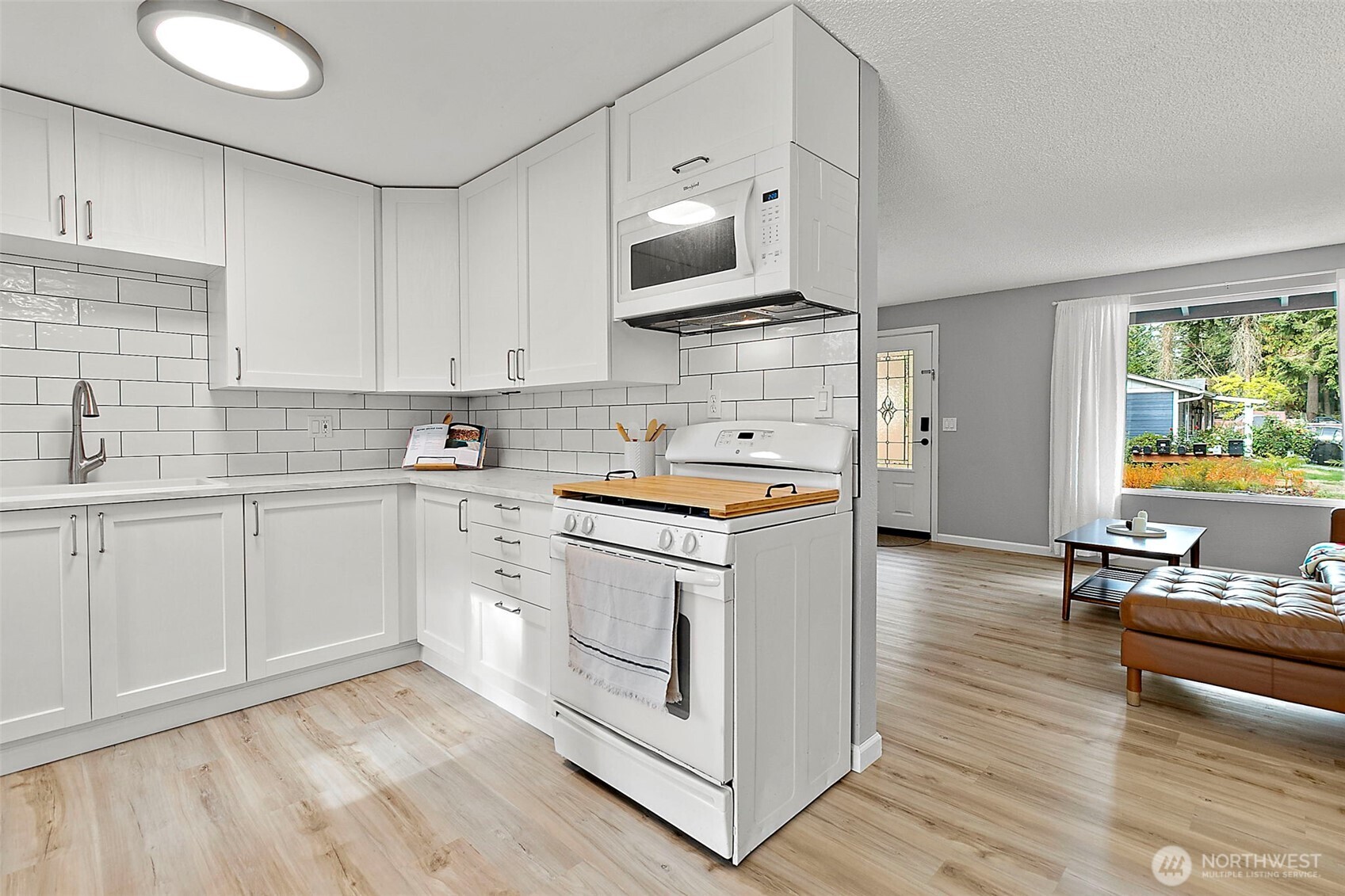 26104 195th Place Southeast Covington, WA 98042 - Photo 10 of 29 a kitchen with a sink cabinets and wooden floor