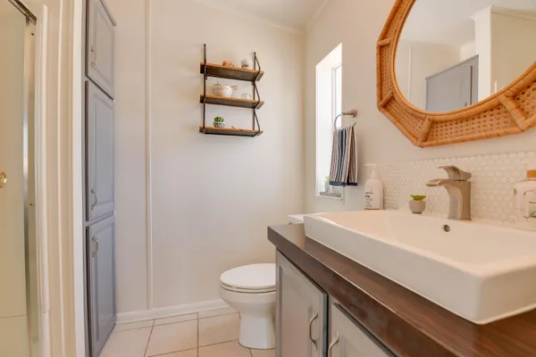 a bathroom with a sink a toilet and a mirror