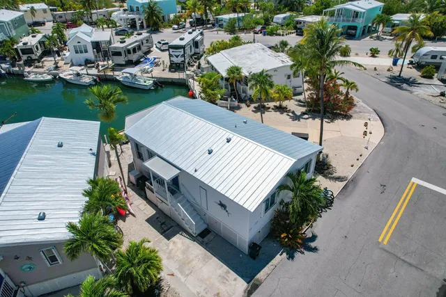 an aerial view of a house with garden space and street view