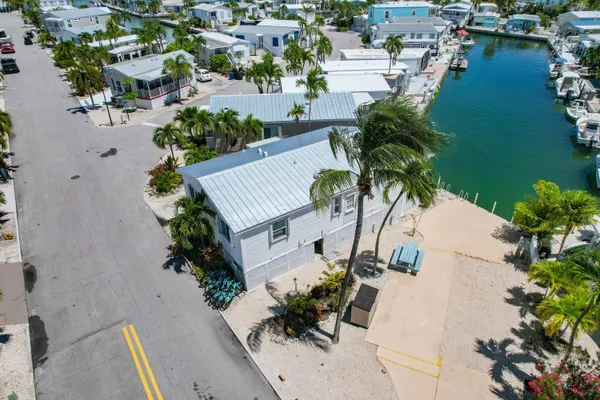 an aerial view of a house with swimming pool garden and patio