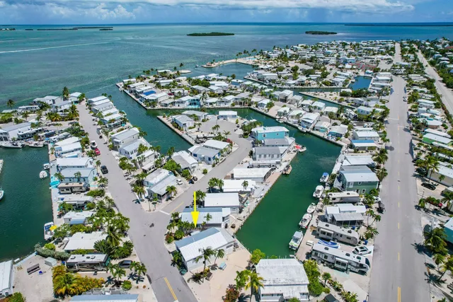 an aerial view of a house with a ocean view
