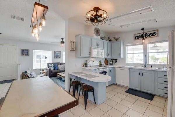 a large white kitchen with a large window