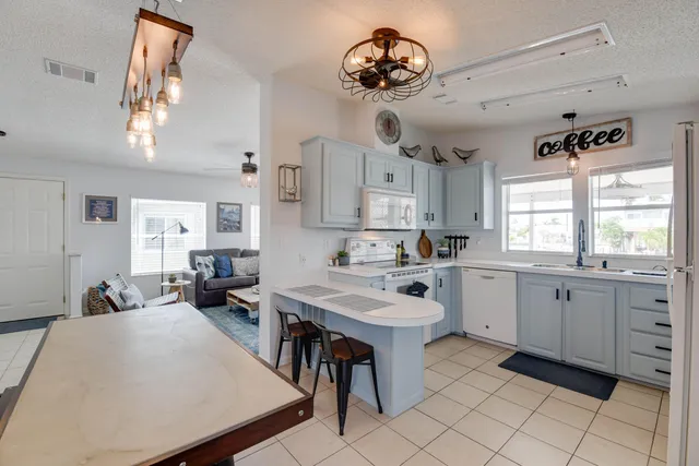 a large white kitchen with a large window
