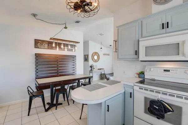 a kitchen with a sink cabinets and appliances