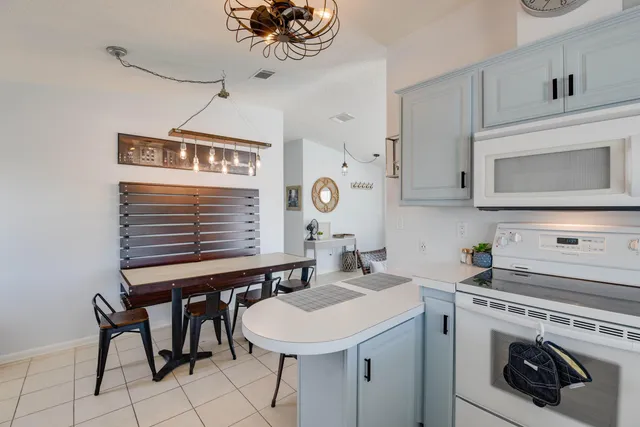 a kitchen with a sink cabinets and appliances
