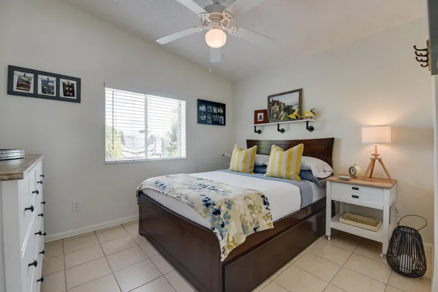 a bed room with a bed and a chair