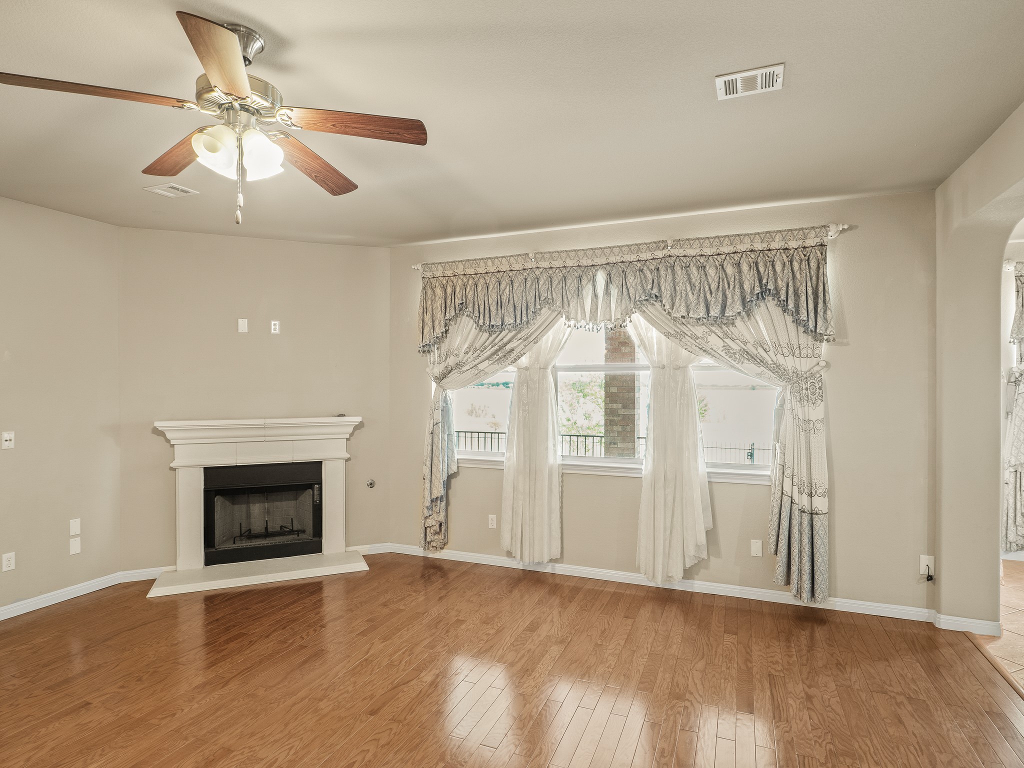17805 Silent Harbor Loop Pflugerville, TX 78660 - Photo 13 of 34 an empty room with wooden floor fireplace and windows
