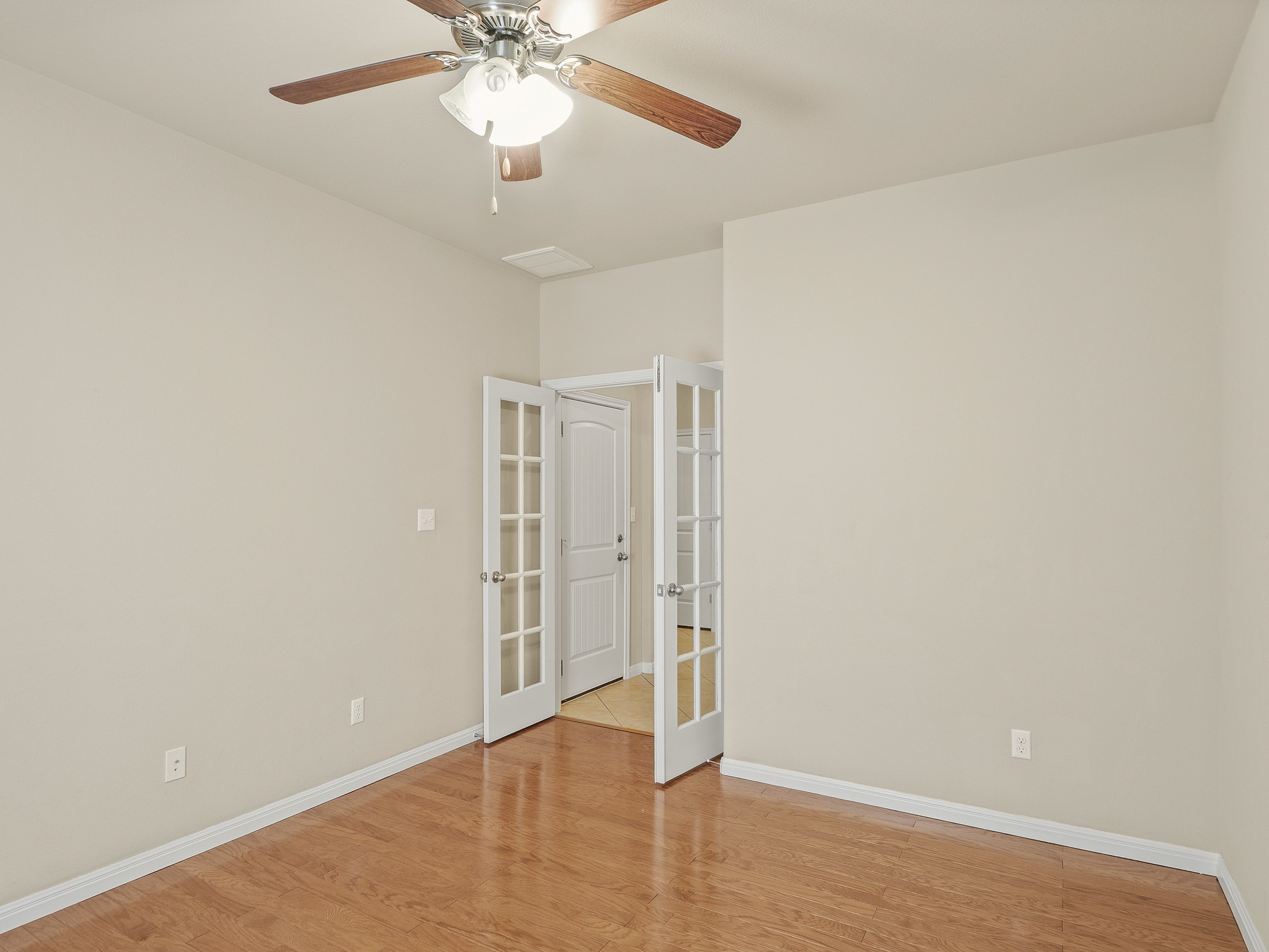 17805 Silent Harbor Loop Pflugerville, TX 78660 - Photo 15 of 34 an empty room with wooden floor fan and windows