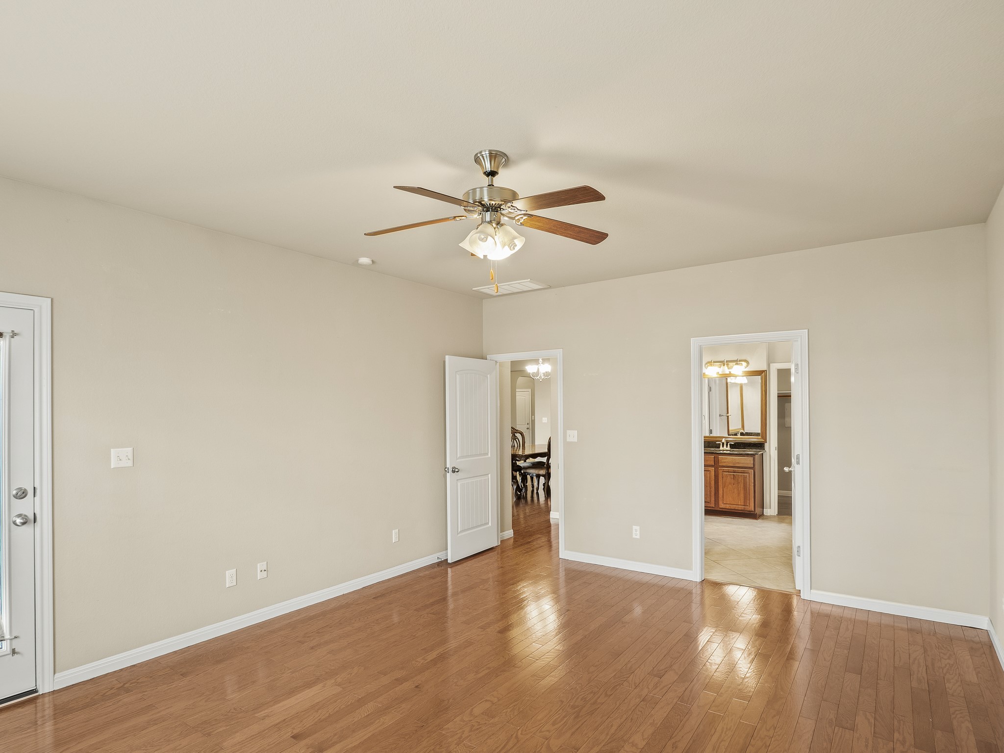 17805 Silent Harbor Loop Pflugerville, TX 78660 - Photo 17 of 34 an empty room with wooden floor and a ceiling fan