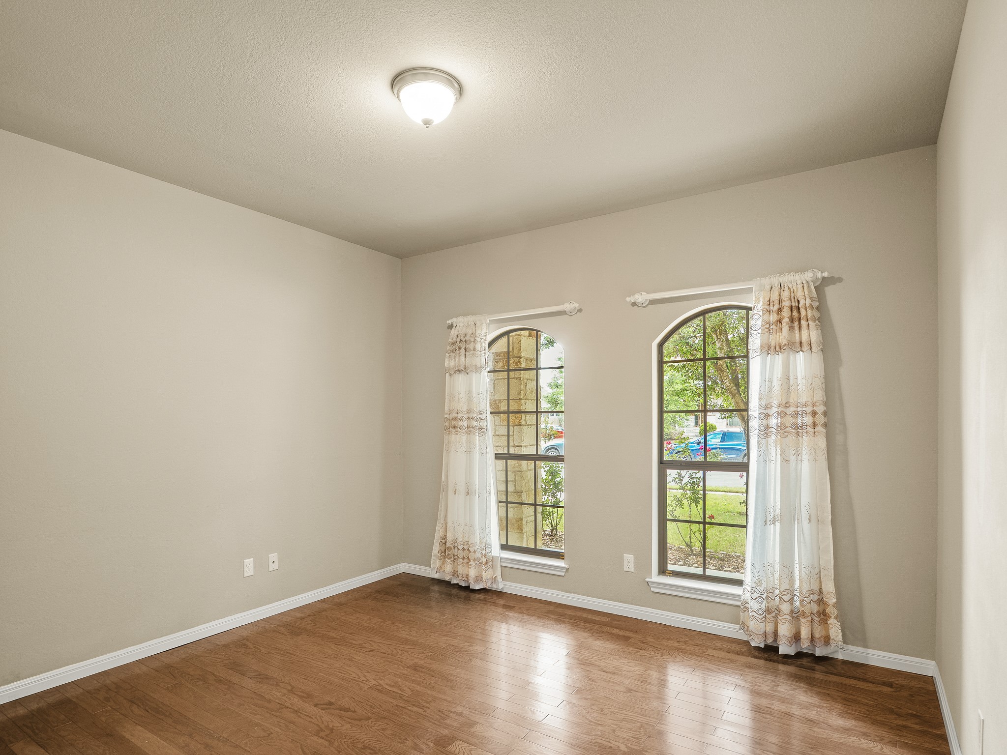 17805 Silent Harbor Loop Pflugerville, TX 78660 - Photo 20 of 34 an empty room with wooden floor and windows