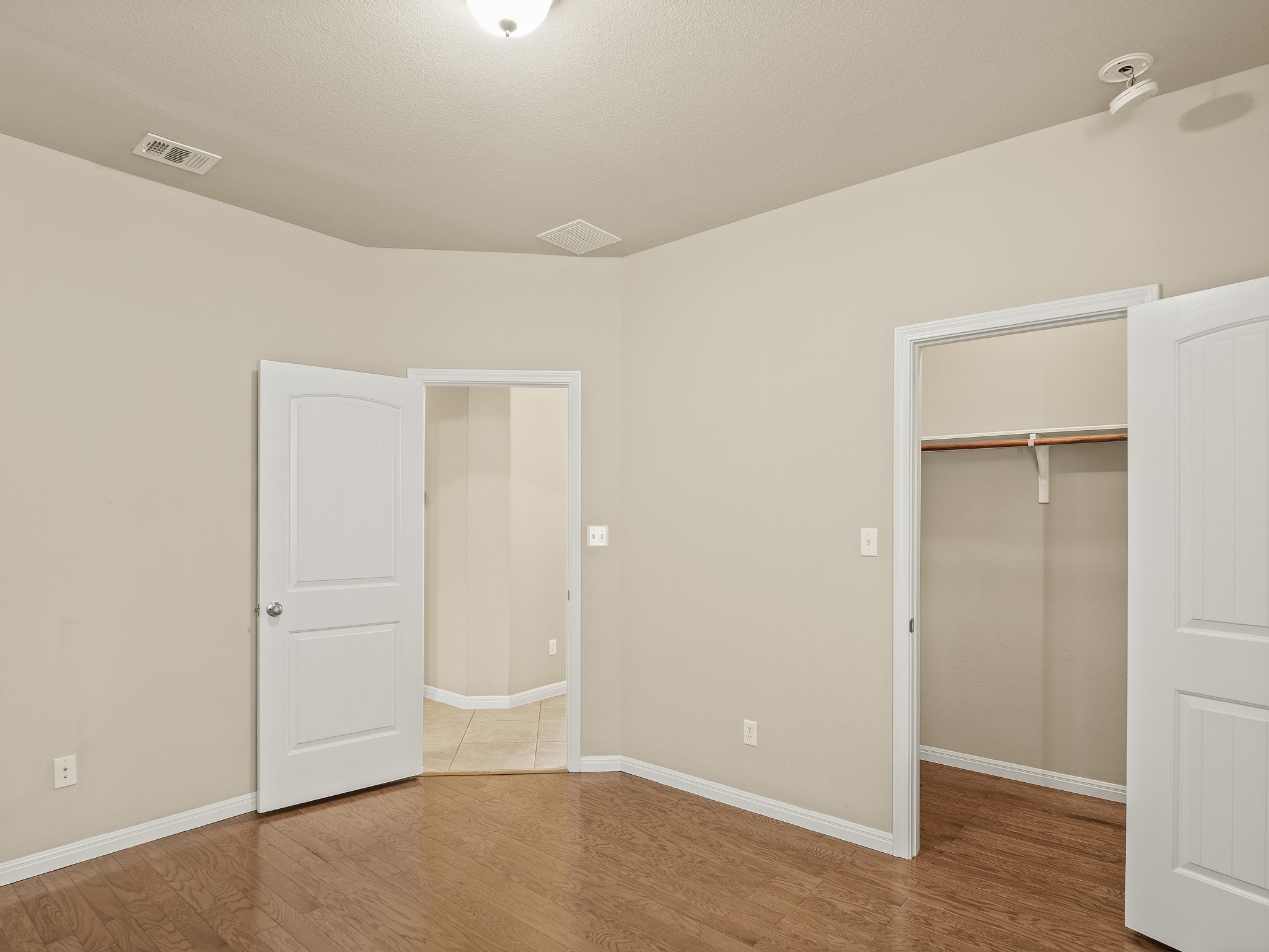 17805 Silent Harbor Loop Pflugerville, TX 78660 - Photo 24 of 34 an empty room with wooden floor and closet