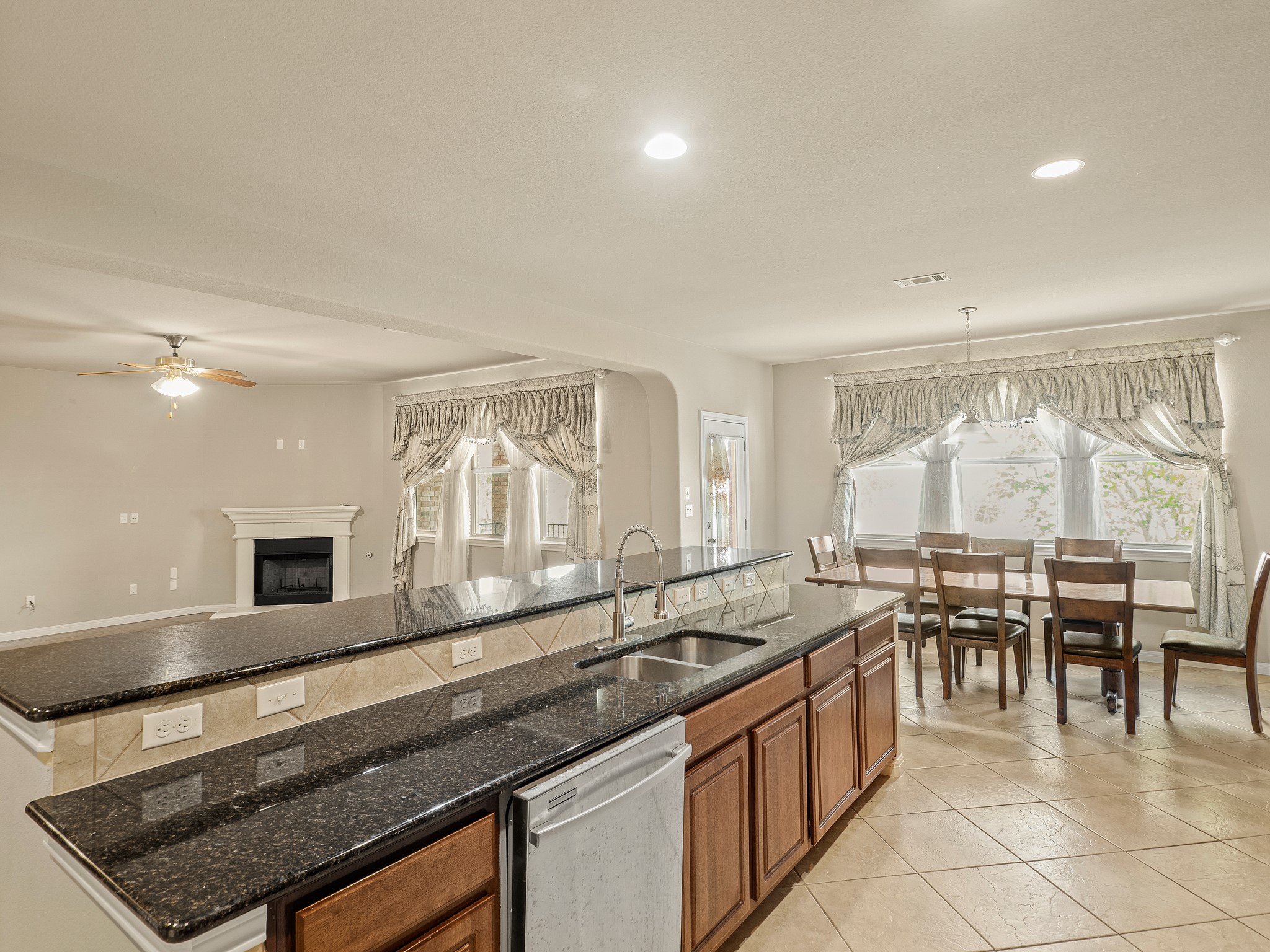 17805 Silent Harbor Loop Pflugerville, TX 78660 - Photo 6 of 34 a large white kitchen with granite countertop a sink and a large window