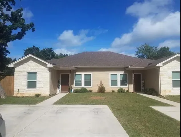 front view of a house with a yard