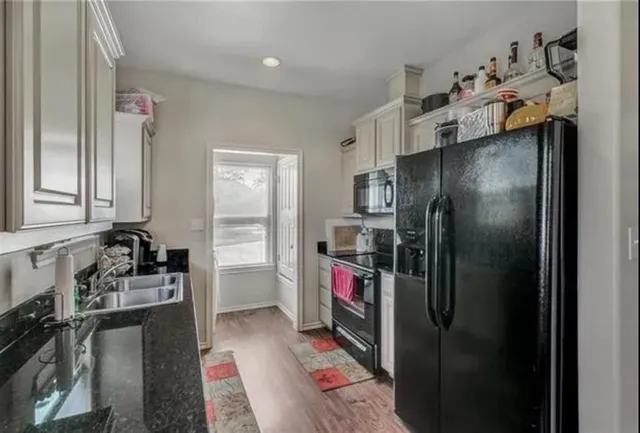a kitchen with a refrigerator and a sink