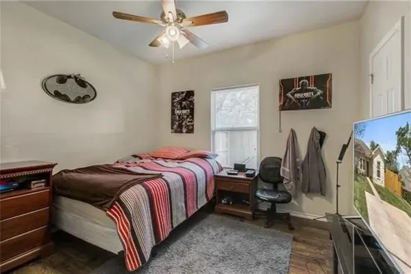 a bedroom with a bed and a chandelier