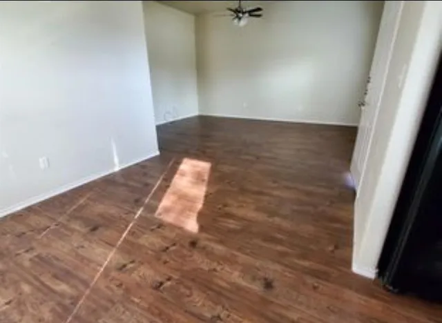 an empty room with wooden floor