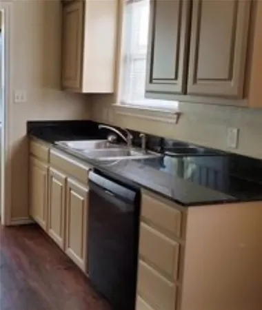 a kitchen with granite countertop a sink and a stove