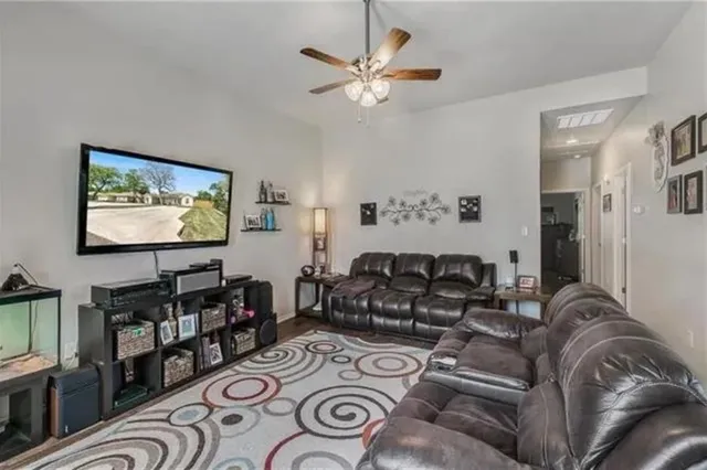a living room with furniture a flat screen tv and a wall painting