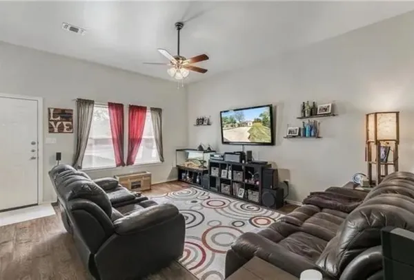 a living room with furniture a couch and a window