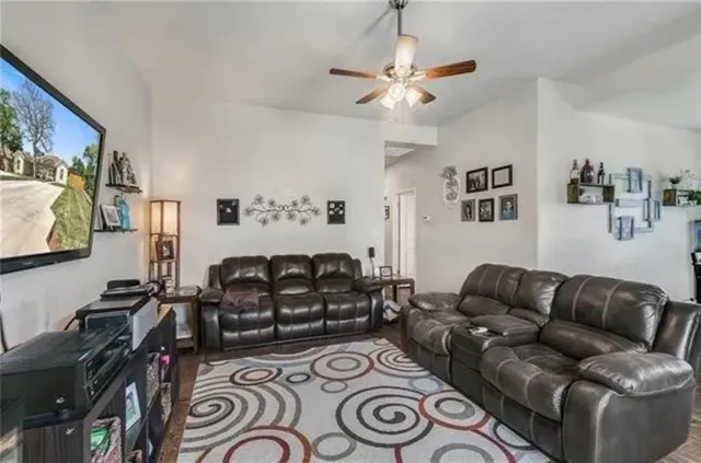 a living room with furniture and a flat screen tv