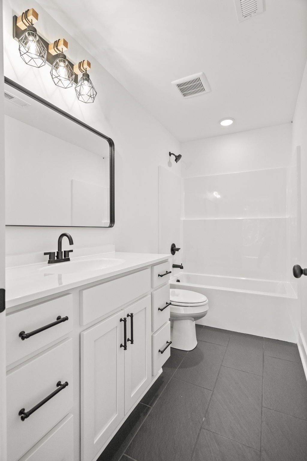 8104 Cedar Grove Road Cross Plains, TN 37049 - Photo 35 of 50 a bathroom with a toilet a sink a tub and mirror