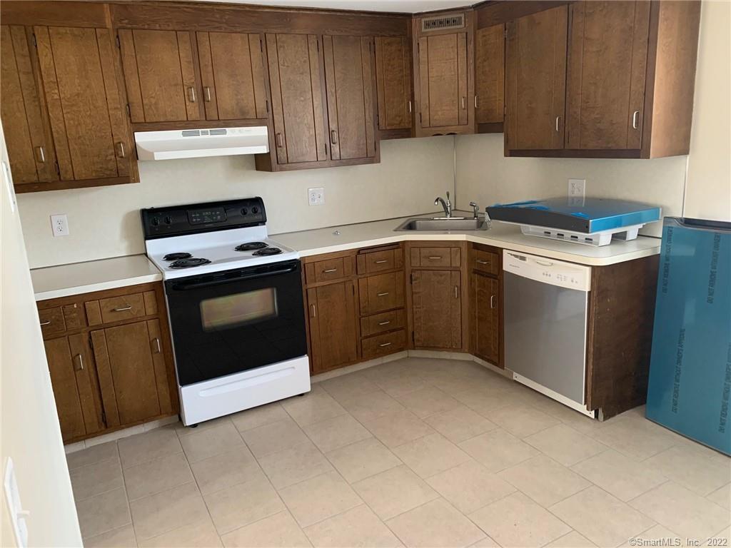 900 South Main Street, Unit 1 Southington, CT 06479 - Photo 3 of 9 a kitchen with cabinets a sink and appliances