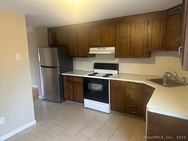900 South Main Street, Unit 1 Southington, CT 06479 - Photo 4 of 9 a kitchen with stainless steel appliances a stove a sink and a refrigerator