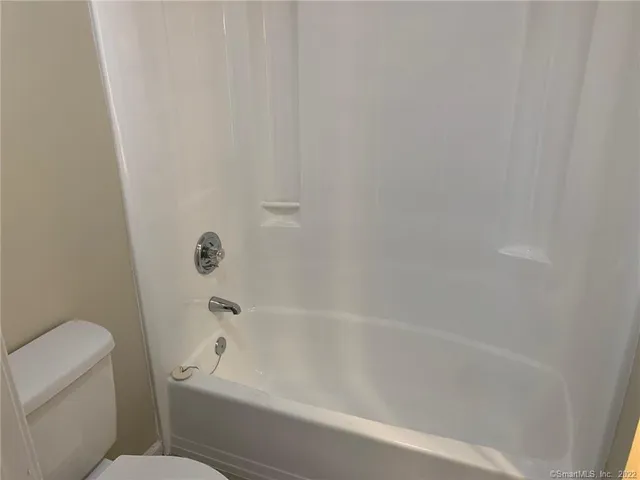 a bathroom with a bathtub and toilet