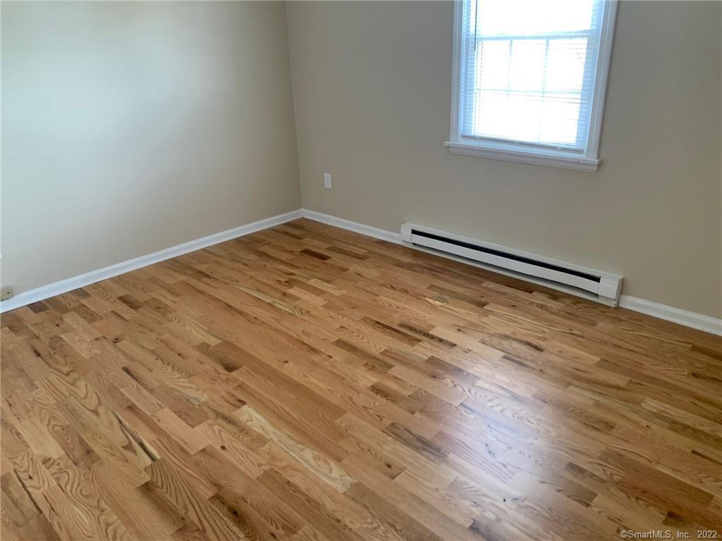 900 South Main Street, Unit 1 Southington, CT 06479 - Photo 9 of 9 an empty room with wooden floor and windows