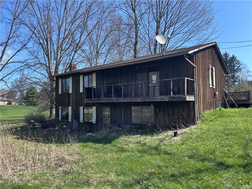 2813 Trares Road Mogadore, OH 44260 - Photo 2 of 16 Back of property featuring a lawn and a chimney