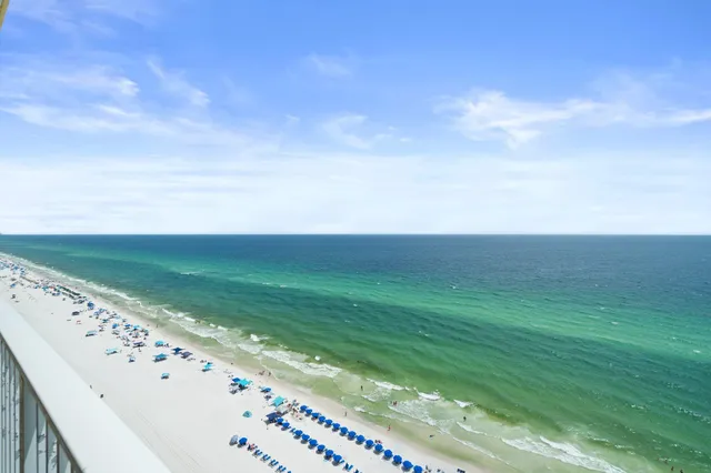 a bedroom with a bed a chandelier and dresser