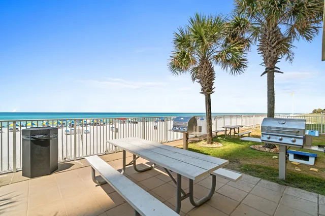 a view of a patio with chairs and table on the patio