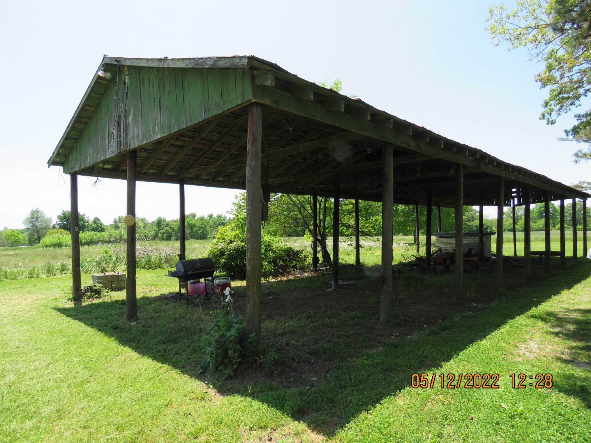 1689 Meister Hills Road Deer Lodge, TN 37726 - Photo 18 of 19 a view of a yard with a table and chairs under an umbrella