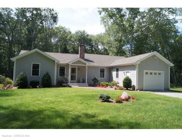 329 Wolf Den Road Brooklyn, CT 06234 - Photo 1 of 1 a front view of a house with a yard and trees