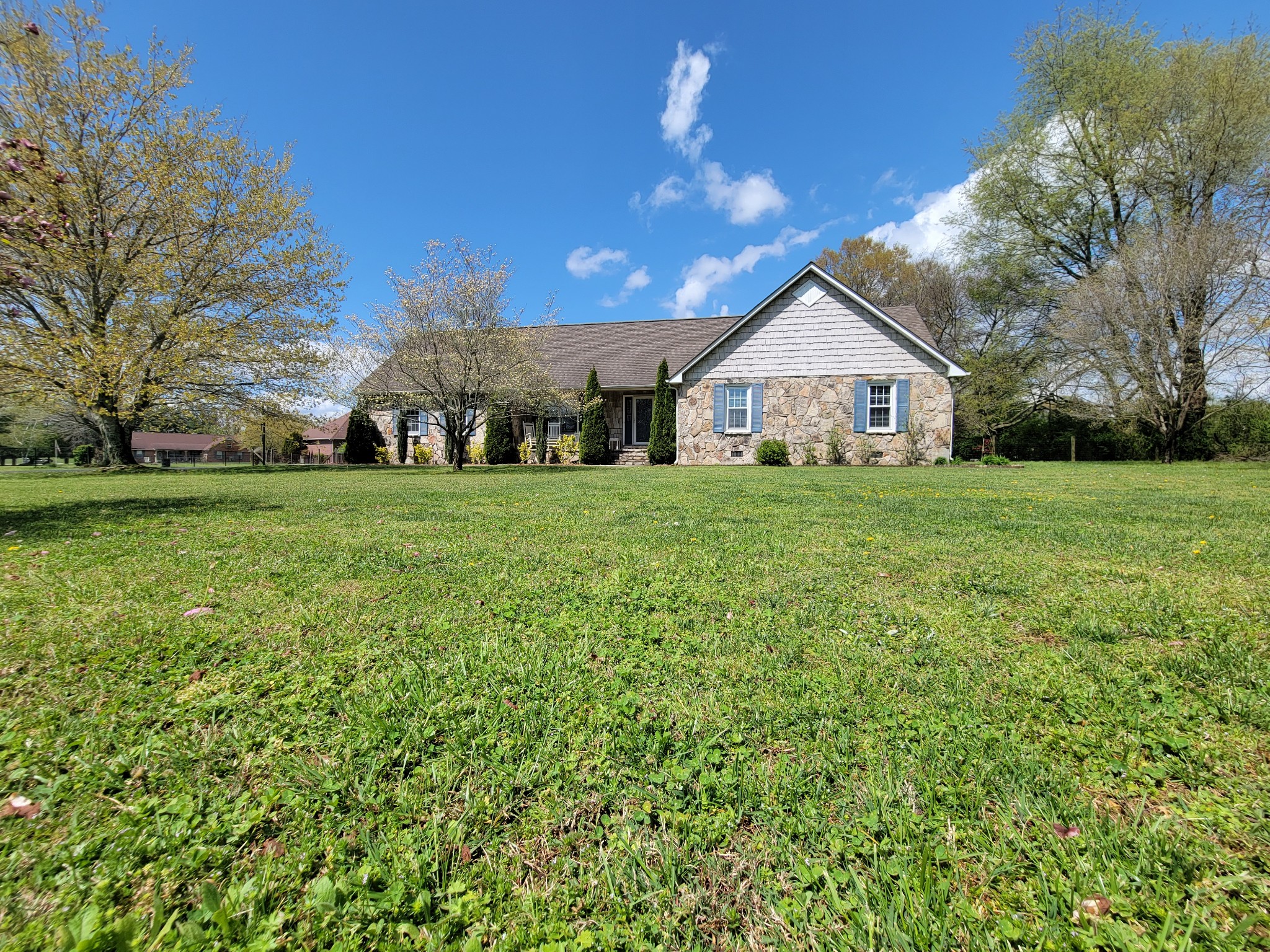 249 Wakefield Drive Manchester, TN 37355 - Photo 2 of 46 a view of a house with a big yard and large trees