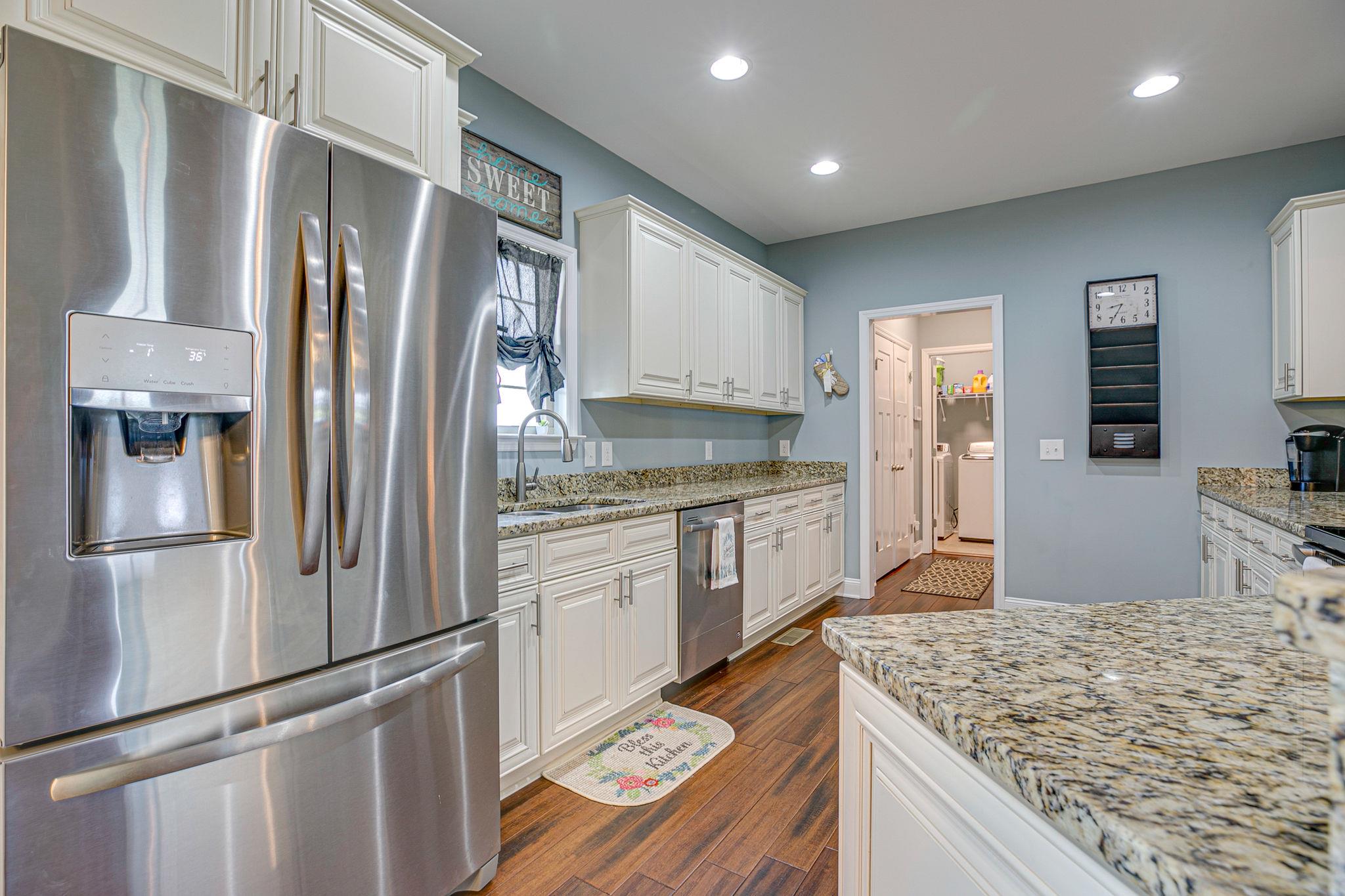 3269 Midland Road Bell Buckle, TN 37020 - Photo 13 of 30 a kitchen with stainless steel appliances granite countertop sink refrigerator and microwave