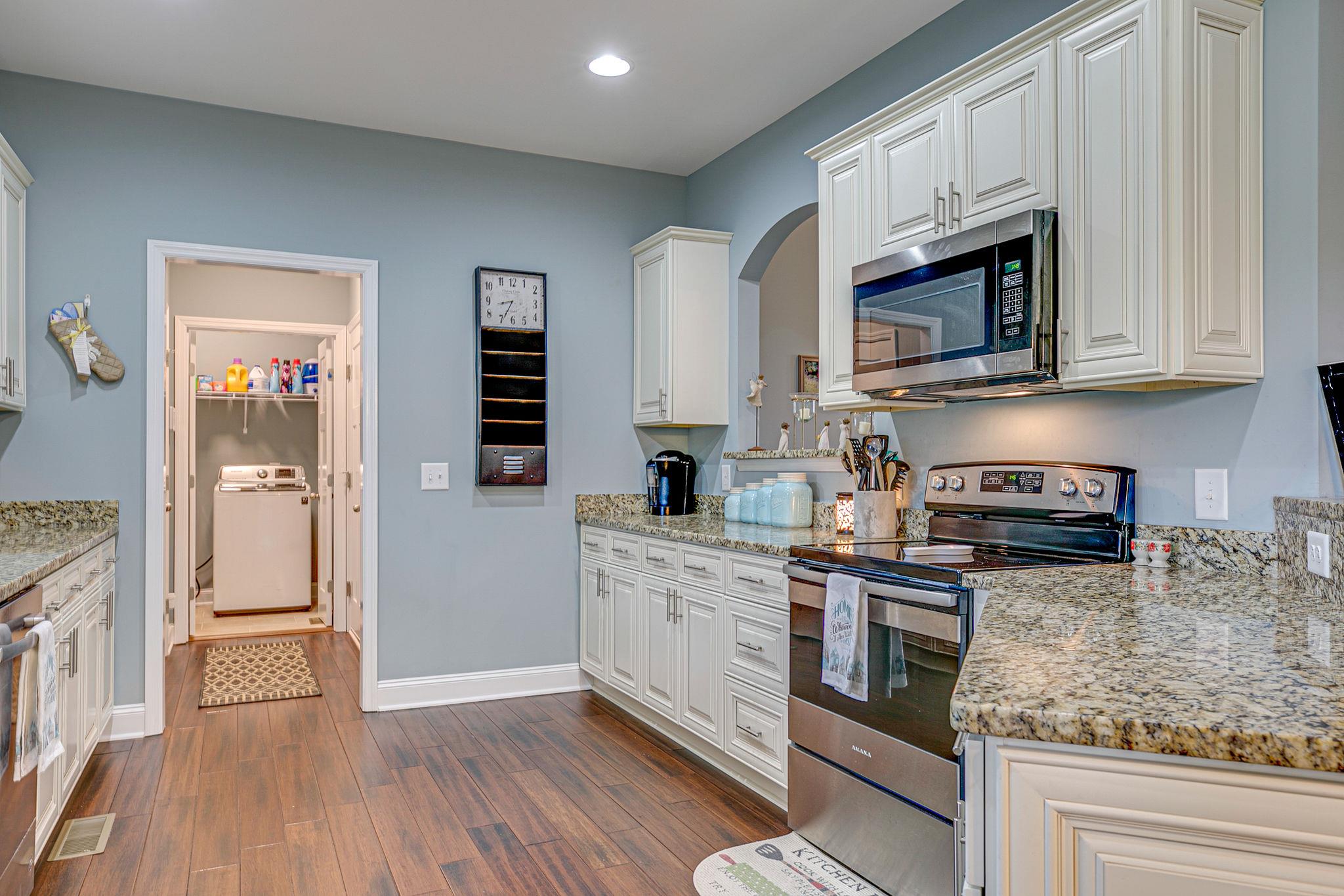 3269 Midland Road Bell Buckle, TN 37020 - Photo 14 of 30 a kitchen with stainless steel appliances granite countertop a stove a sink and a microwave