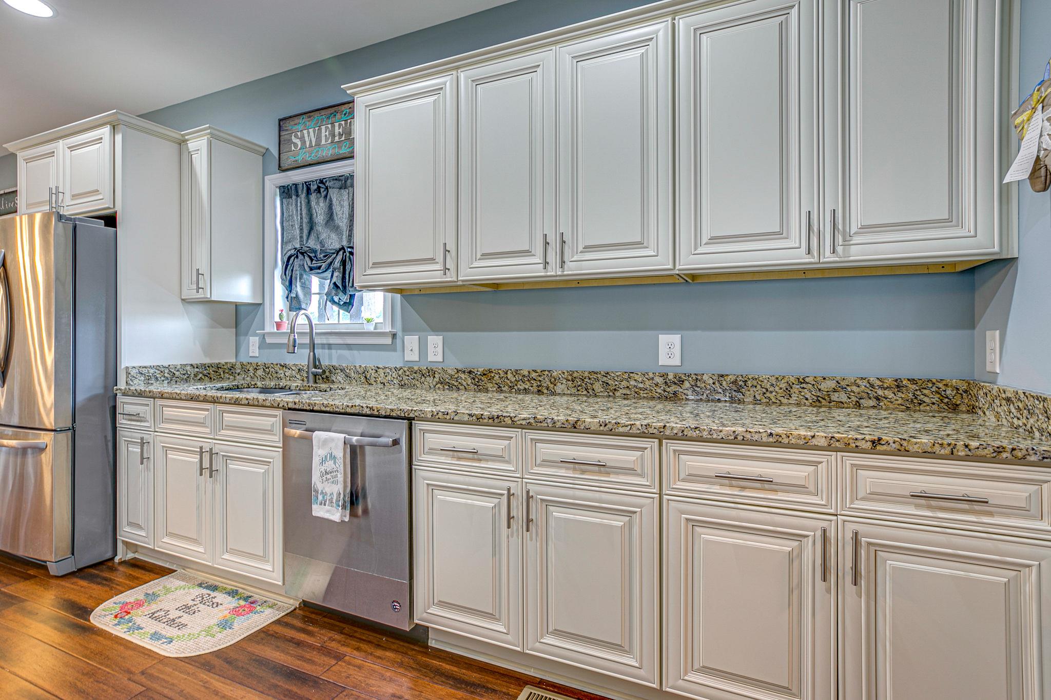 3269 Midland Road Bell Buckle, TN 37020 - Photo 15 of 30 a kitchen with granite countertop white cabinets and stainless steel appliances