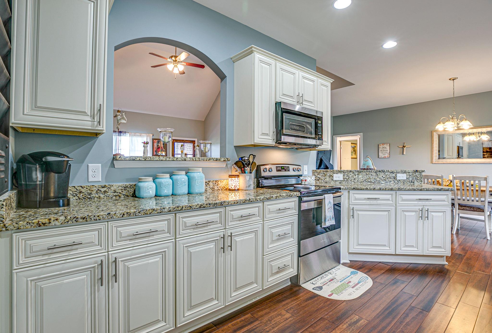 3269 Midland Road Bell Buckle, TN 37020 - Photo 16 of 30 a kitchen with granite countertop white cabinets and white appliances