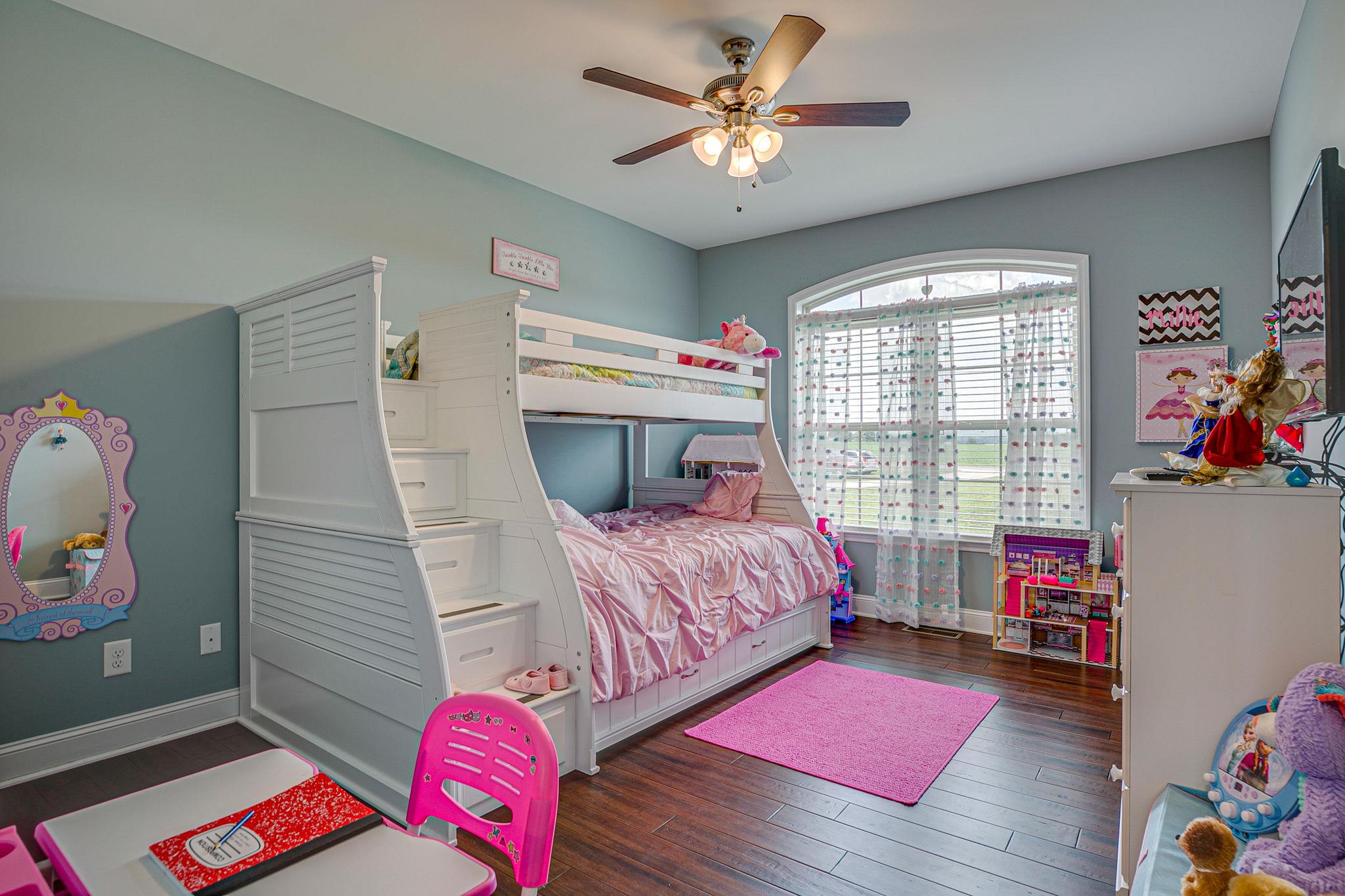 3269 Midland Road Bell Buckle, TN 37020 - Photo 23 of 30 a bedroom with a bed and a chandelier
