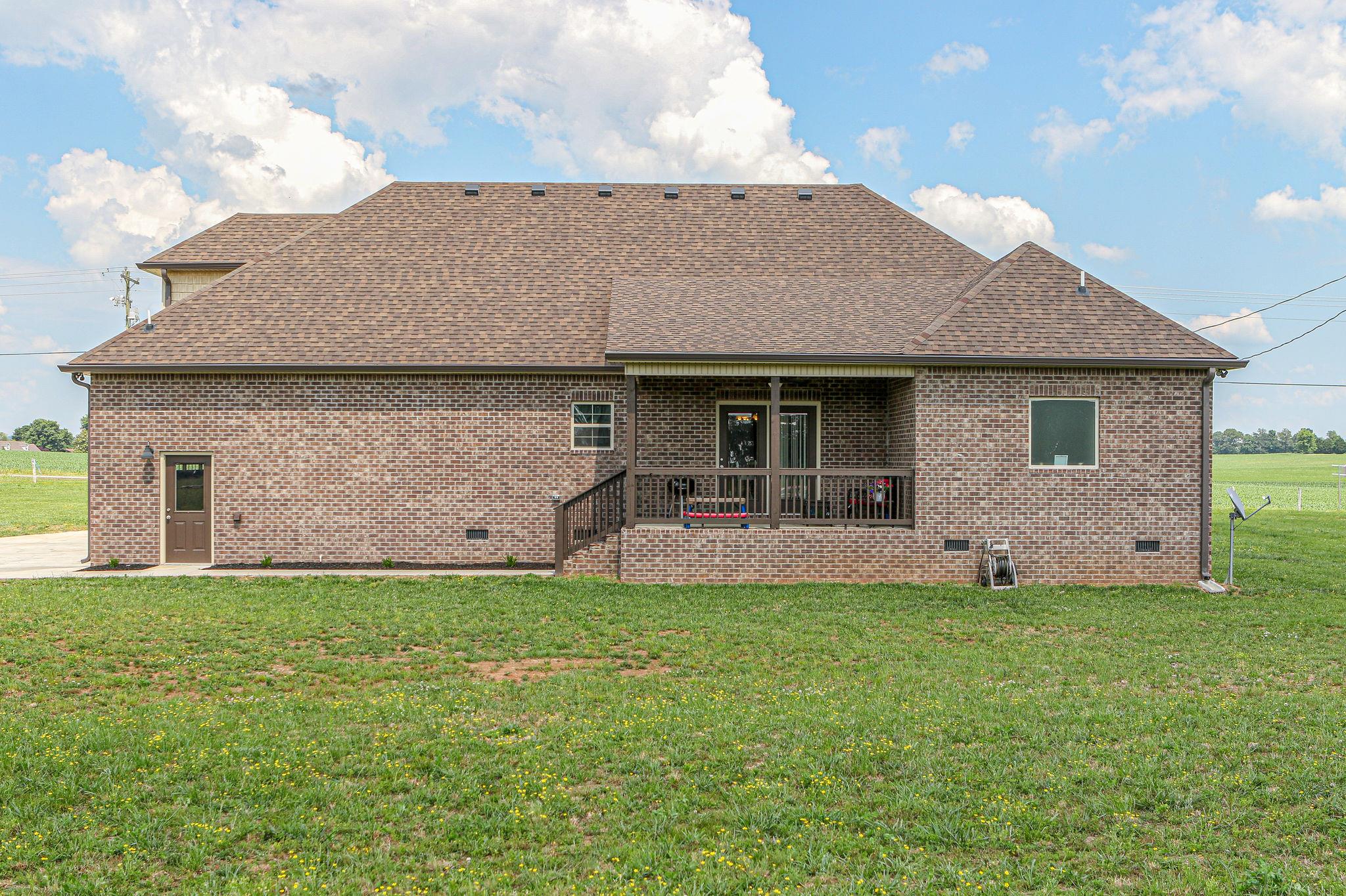 3269 Midland Road Bell Buckle, TN 37020 - Photo 27 of 30 a front view of a house with a yard and garage