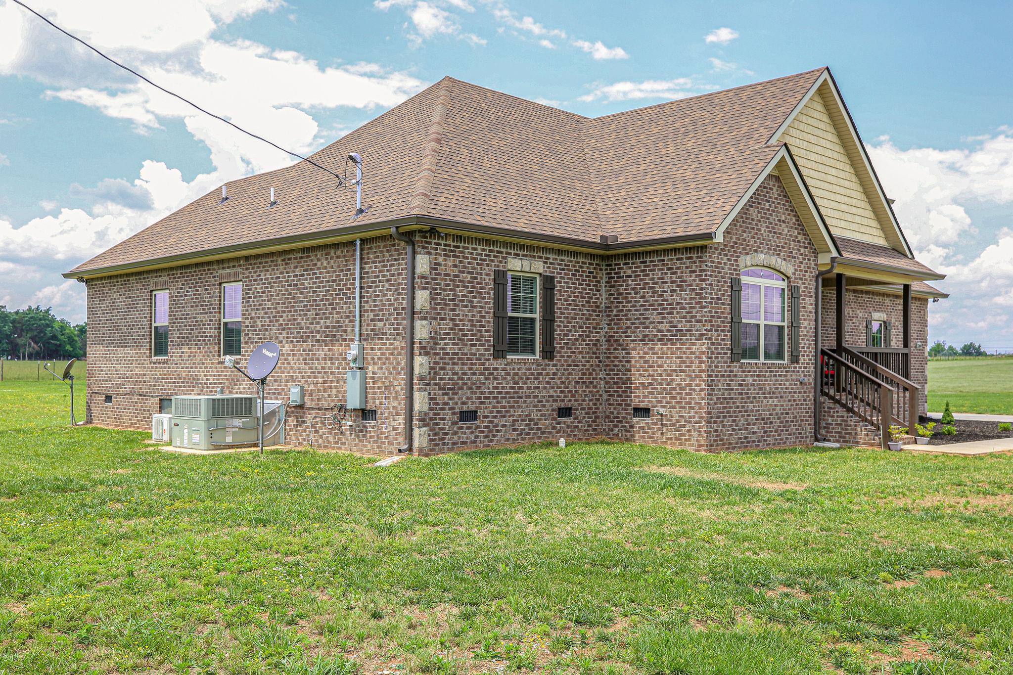 3269 Midland Road Bell Buckle, TN 37020 - Photo 3 of 30 a view of a house with a yard and sitting area